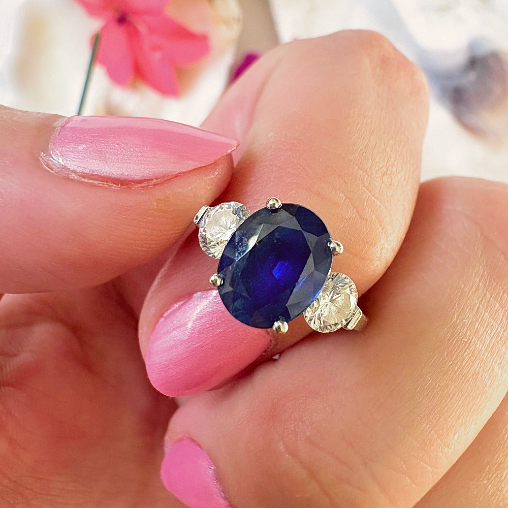 Close-up of the oval blue sapphire and round diamonds